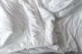 White linen blanket in hotel bedroom. Close-up detail of messy white blanket. Comfortable bed with soft white duvet. Sleep tight Royalty Free Stock Photo