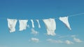 White linen dries on the rope against the blue sky Royalty Free Stock Photo