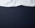 White linen towel on blue wooden background, top view Royalty Free Stock Photo