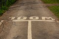 White lines and 100 meter marking painted on the asphalt of a road Royalty Free Stock Photo