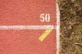 White lines and texture of running racetrack, red rubber racetracks in small stadium Royalty Free Stock Photo