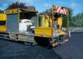 White lining machine preparing road paint by heating to high temperature and melting it for application on road tarmac surface