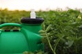 White little bottle of pesticide, herbicide for protecting plants from diseases and pests with mock up stands on