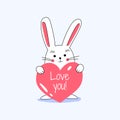 White little cute lovely rabbit holding red heart with love you typograpy and smiling, celebrating Valentine`s Day. Isolated