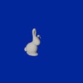White little rabbit figurine for Chinese New Year on a navy blue color background Flat lay concept