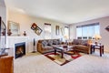 White living room with fireplace and colorful rug Royalty Free Stock Photo