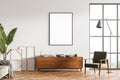 White living room wall with canvas and sideboard near armchair Royalty Free Stock Photo