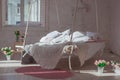 White loft interior in classic scandinavian style. Hanging bed suspended from the ceiling. Cozy large folded beige plaid Royalty Free Stock Photo