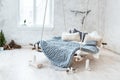 White loft interior in classic scandinavian style. Hanging bed suspended from the ceiling. Cozy large folded gray plaid Royalty Free Stock Photo