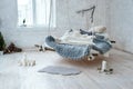 White loft interior in classic scandinavian style. Hanging bed suspended from the ceiling. Cozy large folded gray plaid Royalty Free Stock Photo