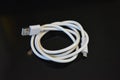 White long wire for computer and office equipment, Usb cable microusb connector on a black glossy surface. Royalty Free Stock Photo