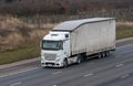 White lorry with trailer in motion on the motorway Royalty Free Stock Photo