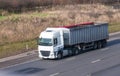 White lorry with trailer in motion on the motorway Royalty Free Stock Photo