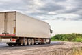 White lorry with white trailer over blue sky on the road Royalty Free Stock Photo