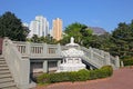 White lotus flower fountain in Nan Lian Garden near Chi Lin Nunnery with city skyscrappers in the background, Hong Kong