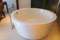 White luxury round bathtub in sexy bathroom in hotel bedroom for honeymoon holidays