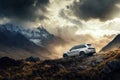 White luxury SUV conquering rugged mountain terrain with dramatic storm clouds and golden sunlight breaking through creating Royalty Free Stock Photo