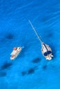 White luxury yacht against azure sea with motor boat