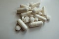 White magnesium citrate capsules and vitamin K tablets in a heap
