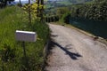 A white mailbox on the side of the road Pesaro, Italy Royalty Free Stock Photo