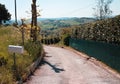 A white mailbox on the side of the road Pesaro, Italy Royalty Free Stock Photo