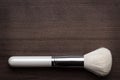 White make-up brush on wooden table Royalty Free Stock Photo
