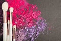 White make up brushes and violet and pink eyeshadows Royalty Free Stock Photo