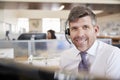 White male call centre worker smiling to camera