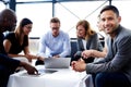 White male executive smiling at camera during meeting