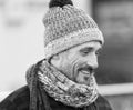 White male in winter knitted hat and scarf. Portrait of smiling white guy on street. Bearded urban man in woolen hat Royalty Free Stock Photo