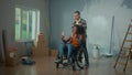 A white man and an African American disabled woman in a wheelchair are talking on video call using a mobile phone. A Royalty Free Stock Photo