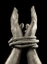 White man hands wrapped with rope around wrists in victim abused in captivity, slave of work and respect for human rights concept