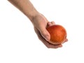 White man holds a blood orange in his hand Royalty Free Stock Photo