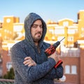 White man looking at the camera with an electric drill of batteries without wires to make DIY. Royalty Free Stock Photo