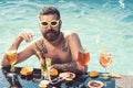 White man muscle nude topless with cocktail drink at swimming pool in fresh feeling. Royalty Free Stock Photo