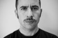 White man with a prominent mustache looking straight at the camera Royalty Free Stock Photo