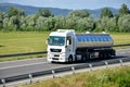 White MAN truck coupled with tank semi-trailer drived on slovak D1 highway in countryside. Royalty Free Stock Photo