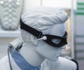 White mannequin of human head with a medical physiotherapy device for the treatment of eye diseases