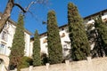 A white mansion with many tall green trees in front of it Royalty Free Stock Photo