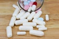 The white many capsules on wood Royalty Free Stock Photo