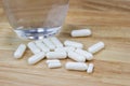 The white many capsules on wood Royalty Free Stock Photo