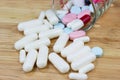 The white many capsules on wood Royalty Free Stock Photo