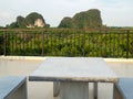 White marble bench table desk and marble chair on roof top with mountain hill and green natural mangrove view Royalty Free Stock Photo