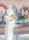 White marble Buddha statue in the folded posture