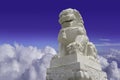 White marble Chinese guardian lion sculpture on blue and cloudy sky background with clipping path Royalty Free Stock Photo