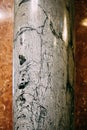 White marble column with black streaks all over the pillar. Royalty Free Stock Photo