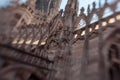 White marble construction on the roof of famous Cathedral Duomo di Milano, piazza in Milan, Italy. Blur and movement Royalty Free Stock Photo