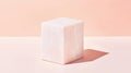 A white marble cube sits on a pink background. Royalty Free Stock Photo