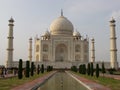 White marble mausoleum with four minarets seen from one of its fountains. Taj Mahal