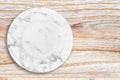 White marble plate placed on wood. Royalty Free Stock Photo